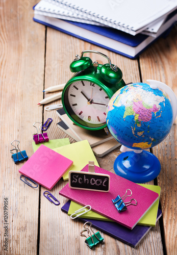 Business accessories, supplies, alarm clock, pencils on rustic wooden table