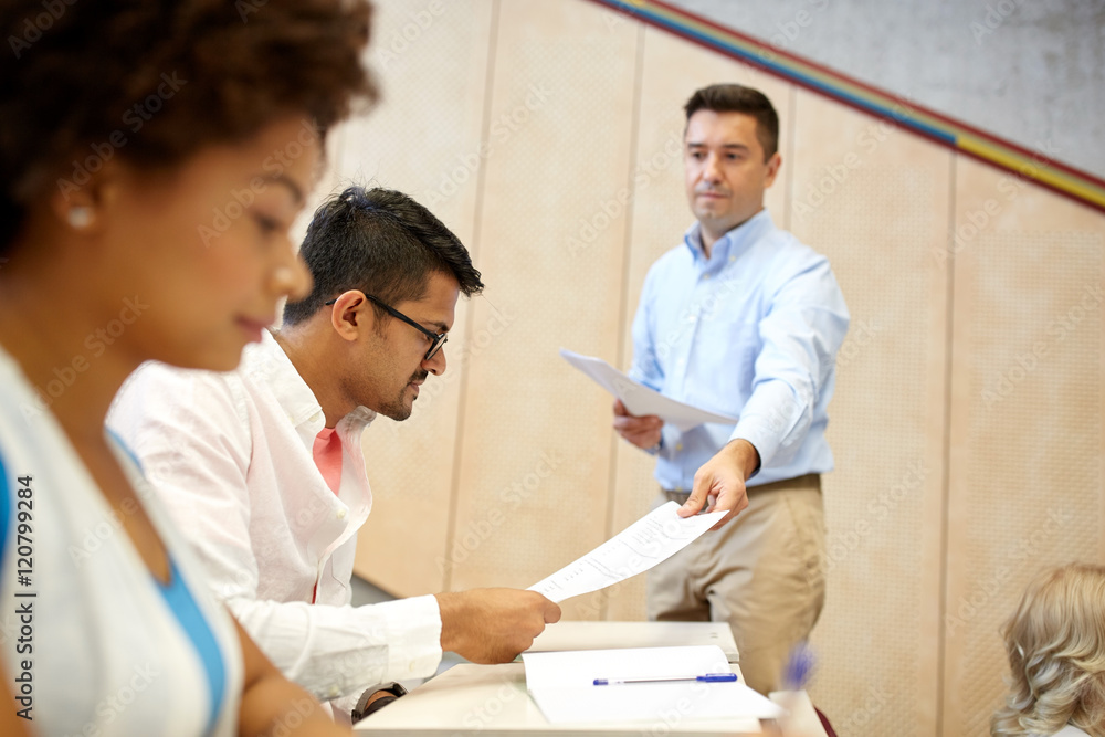 teacher giving tests to students at lecture teacher giving tests to students at lecture