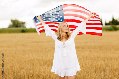 happy woman with american flag on cereal field