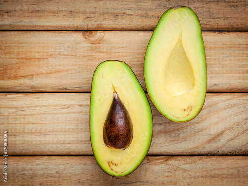 Healthy food concept.Closeup ripe avocado on wooden background.
