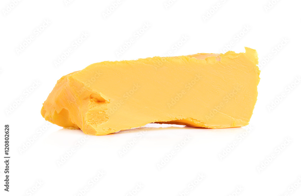 Stick of butter, cut, isolated on white.