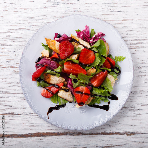 Salad with fresh strawberries,herbs and chicken meat,tossed with balsamic vinaigrette. Healthy food or diet concept.selective focus. photo