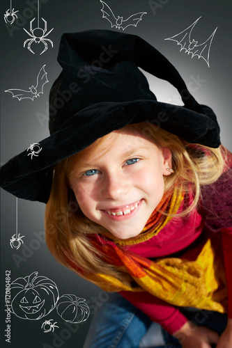 Halloween little girl looking at camera black background