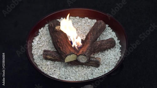 Small open fire pit with ceramic logs