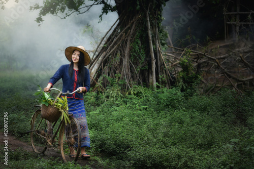 Girl with bicycle. © sirisakboakaew