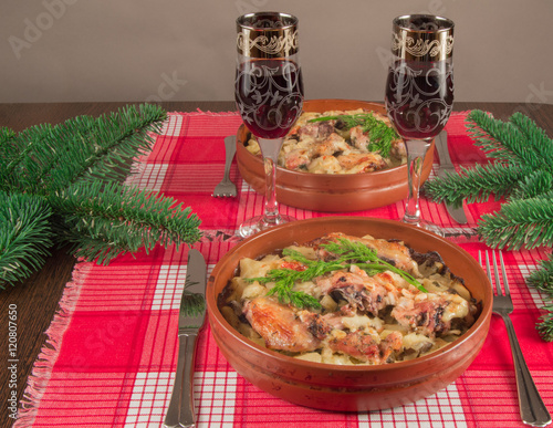 Serving Christmas table. Spruce branches, two glasses of wine, homemade feast photo