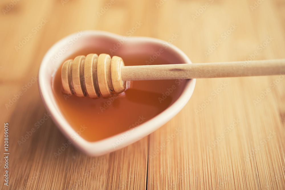 Honey and wooden dipper Honey and wooden dipper