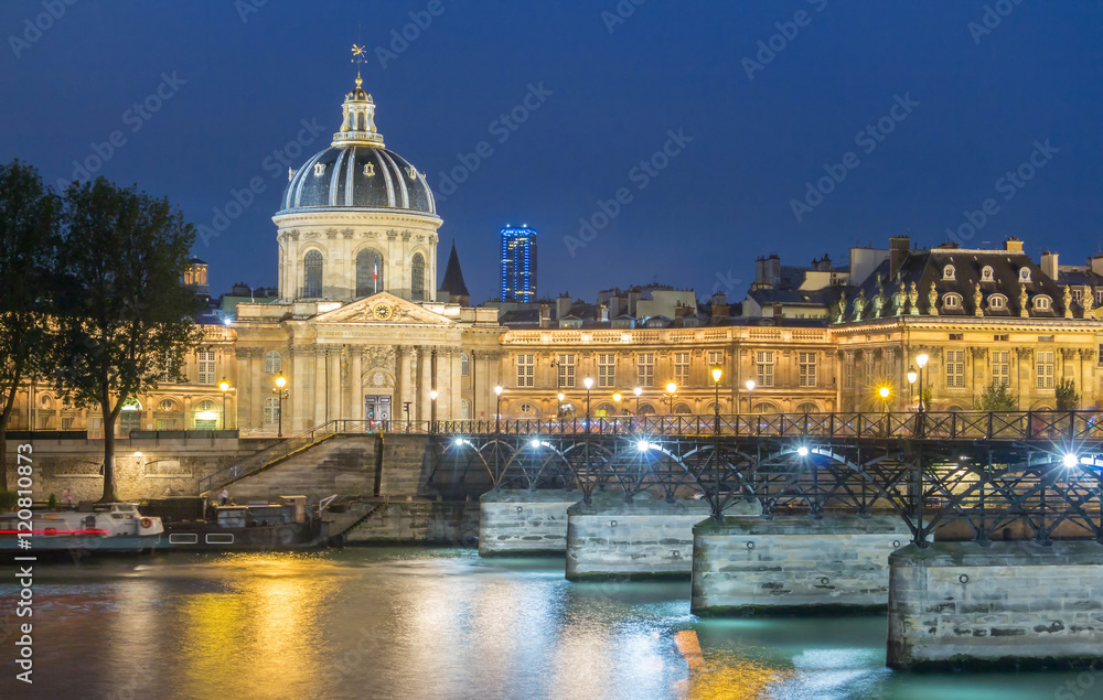 The French Academy et pont des Arts at night , Paris, France.