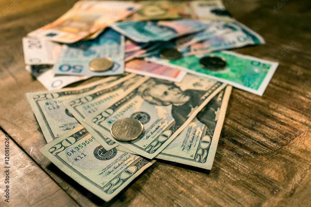 Variable banknotes on wooden table, currency exchange Variable banknotes on wooden table, currency exchange