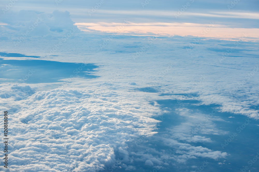 Clouds and sky as seen through window of an aircraft Clouds and sky as seen through window of an aircraft