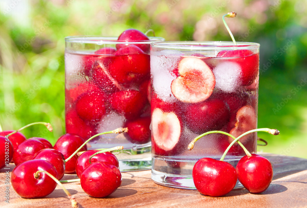 Ice cold cherry drink in glass outdoors