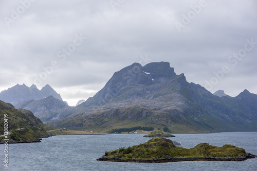 Dramatic summer landscape with sharp mountain peaks in Norway. © strukt