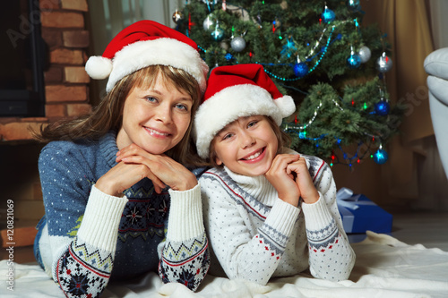 Mother and daughter in santa hat