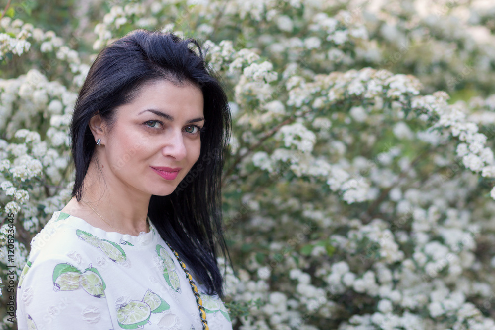 Beautiful woman in the flowered garden. People Beautiful woman in the flowered garden. People
