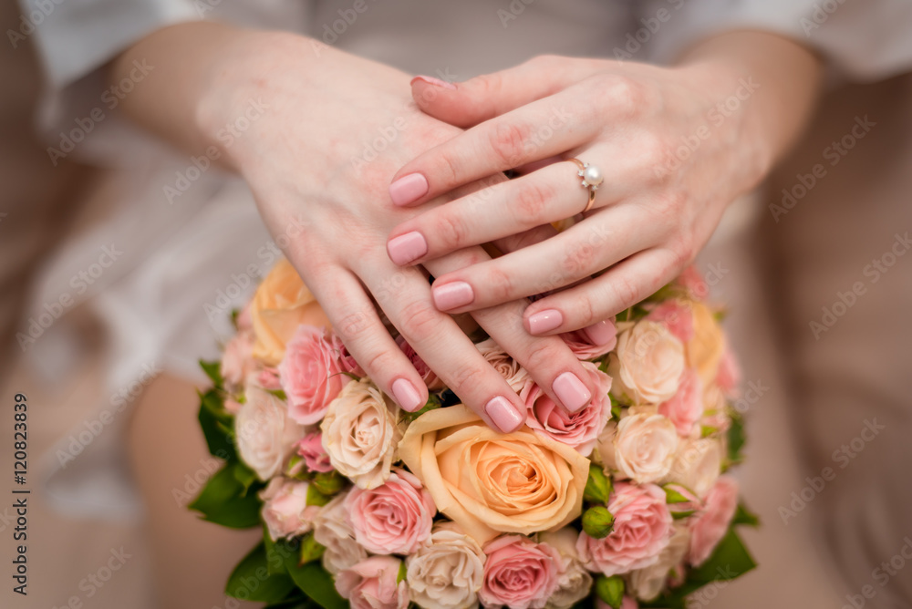 woman hands on wedding bouquet with engegment ring woman hands on wedding bouquet with engegment ring
