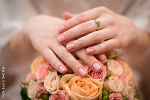 Fototapeta Naklejka Na Ścianę i Meble -  woman hands on wedding bouquet with engegment ring