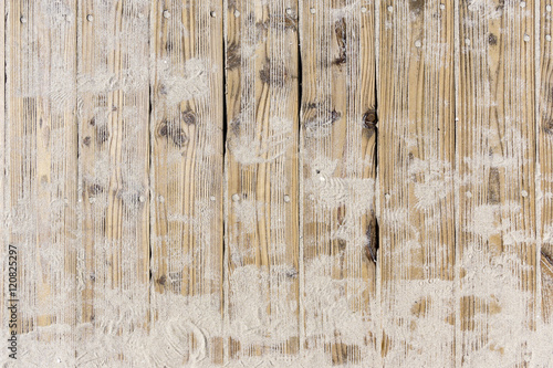 Beach sand on vintage planked wood background - layout with free text space.