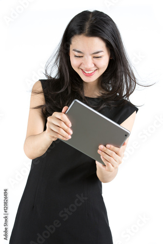 Asian lady playing a game on tablet