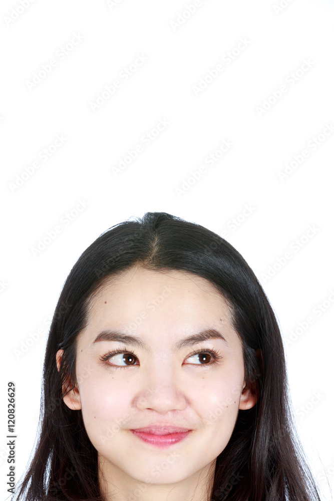 An asian woman thinking and smiling at the same time An asian woman thinking and smiling at the same time