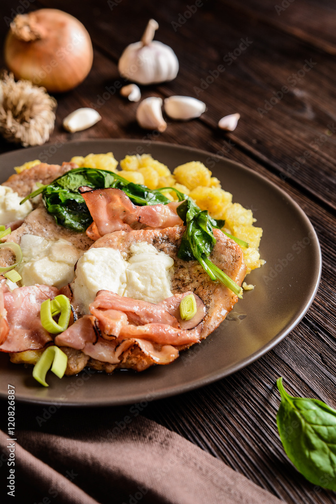 Roasted pork cutlets with bacon, cheese, spinach and potatoes Roasted pork cutlets with bacon, cheese, spinach and potatoes
