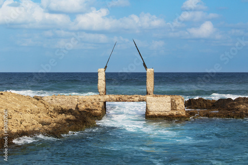 Fotografie Fragment of ancient construction at the coast of the Mediterranean Sea, Neve Yam Beach at Atlit, Israel