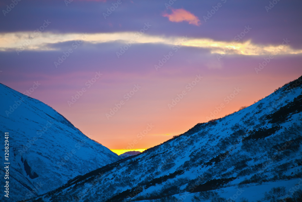 Sunset paints the evening sky in spring in the mountains of Kamchatka