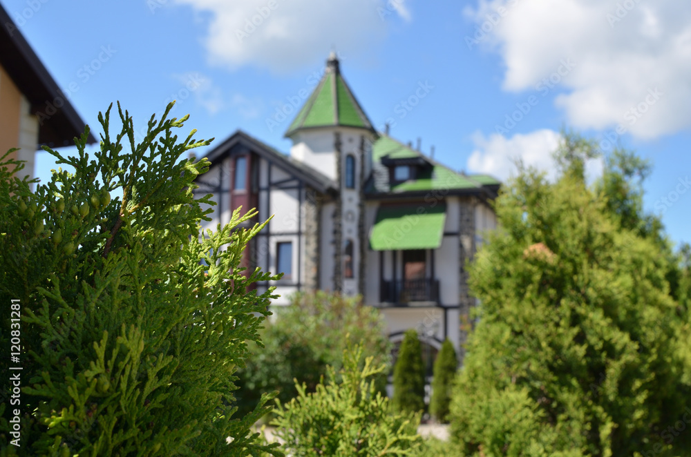 Hidden green and white residence building in castle style