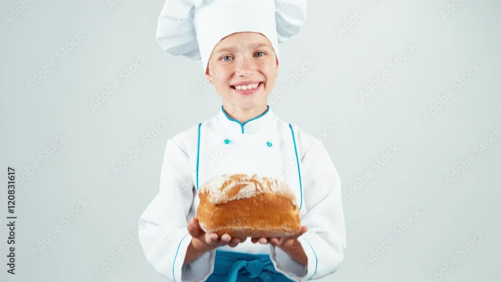 Close up portrait baker holds loaf of bread in her hands and gives you and smiling at camera isolated on white background Close up portrait baker holds loaf of bread in her hands and gives you and smiling at camera isolated on white background