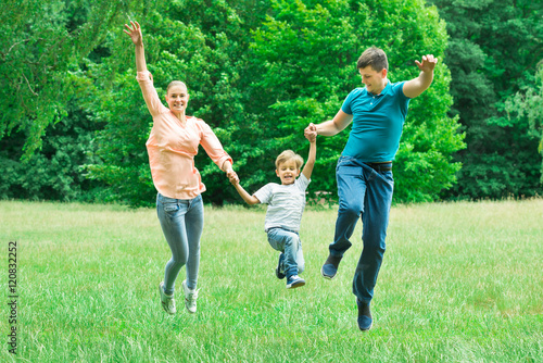 Parents Jumping With Their Son