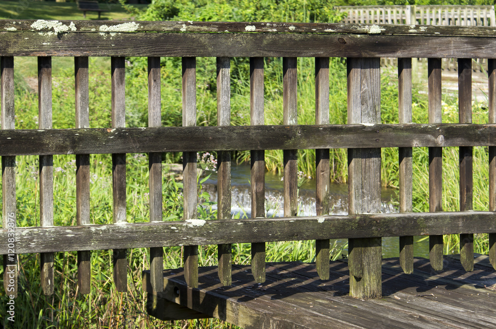 A well worn and weathered wooden fence still standing and doing its job. A well worn and weathered wooden fence still standing and doing its job.