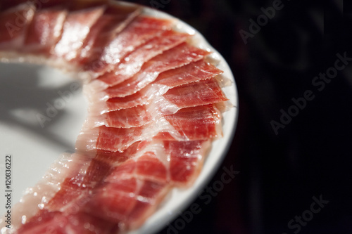 decorated arrangement of iberian cured ham on plate photo