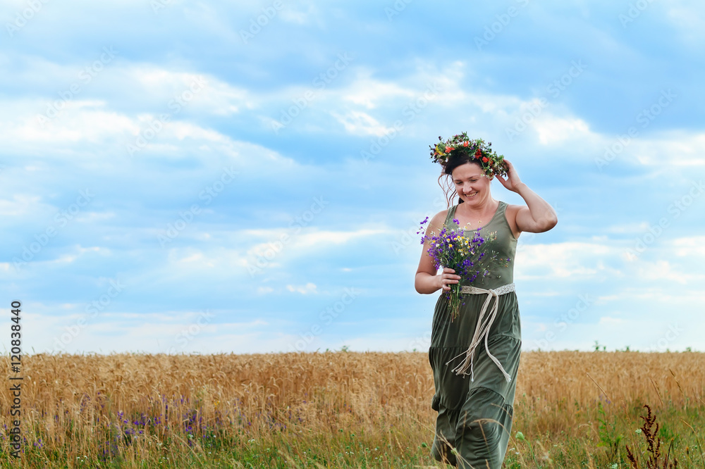 beautiful girl in a wheat field with  wreath on head