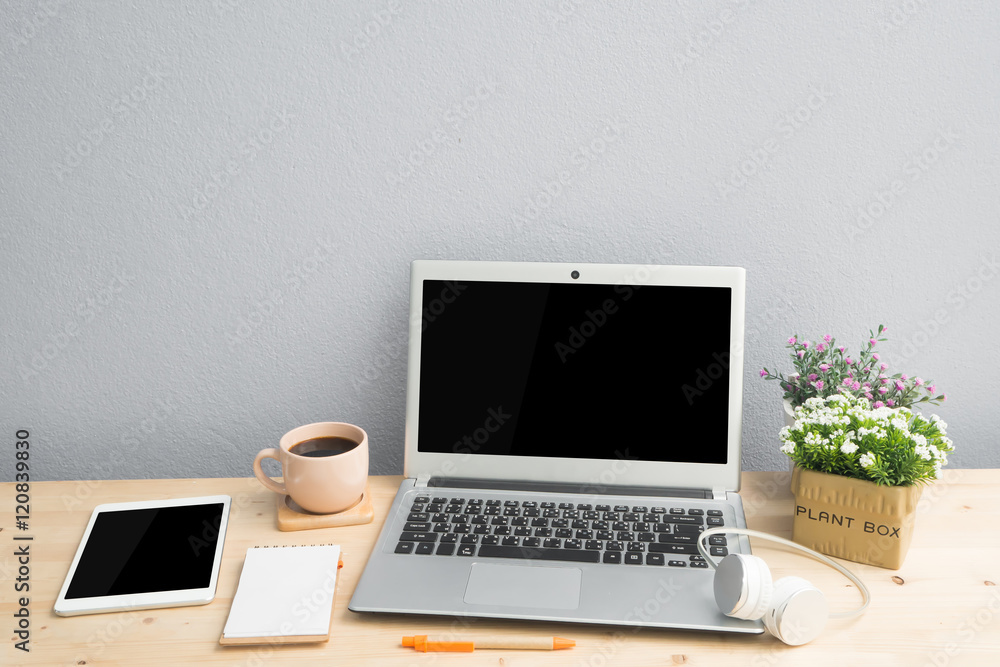 Office desk with blank screen laptop, Note paper, Euphorbia milii flower on terracotta flower pot . Office desk with blank screen laptop, Note paper, Euphorbia milii flower on terracotta flower pot .