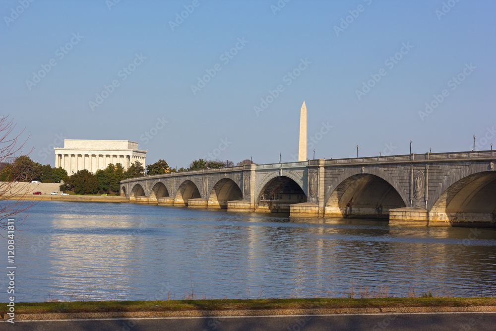 Lincoln Memorial and National Monument at sunset in Washington DC. Memorial Bridge and US capital landmarks across Potomac River.