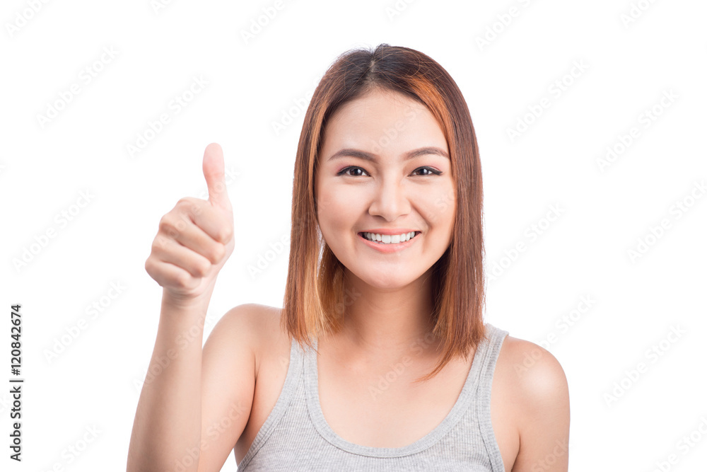 Cheerful lovely girl looking at camera showing thumbs up over wh Cheerful lovely girl looking at camera showing thumbs up over wh