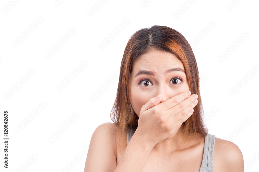 Young adult asian woman holding hand over her mouth over white b Young adult asian woman holding hand over her mouth over white b