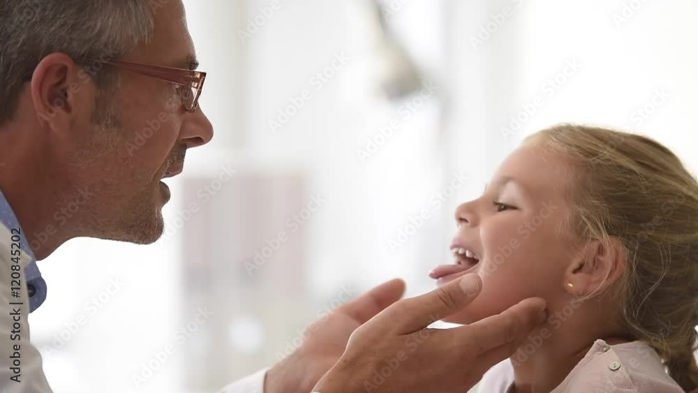 Doctor examining little girl's throat Doctor examining little girl's throat
