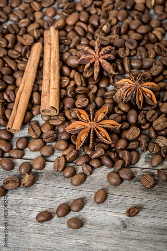 Coffee, cinnamon and Damian on wooden background