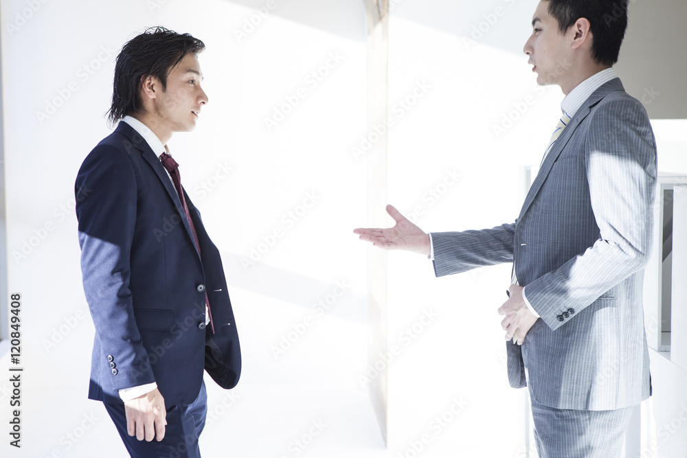 Businessmen are stand talking in the office Businessmen are stand talking in the office