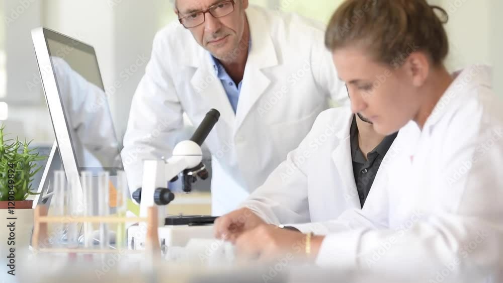 Students in biology attending training with microbiologist Students in biology attending training with microbiologist