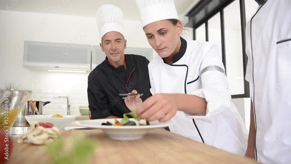 Young chefs presenting dish to teacher Young chefs presenting dish to teacher