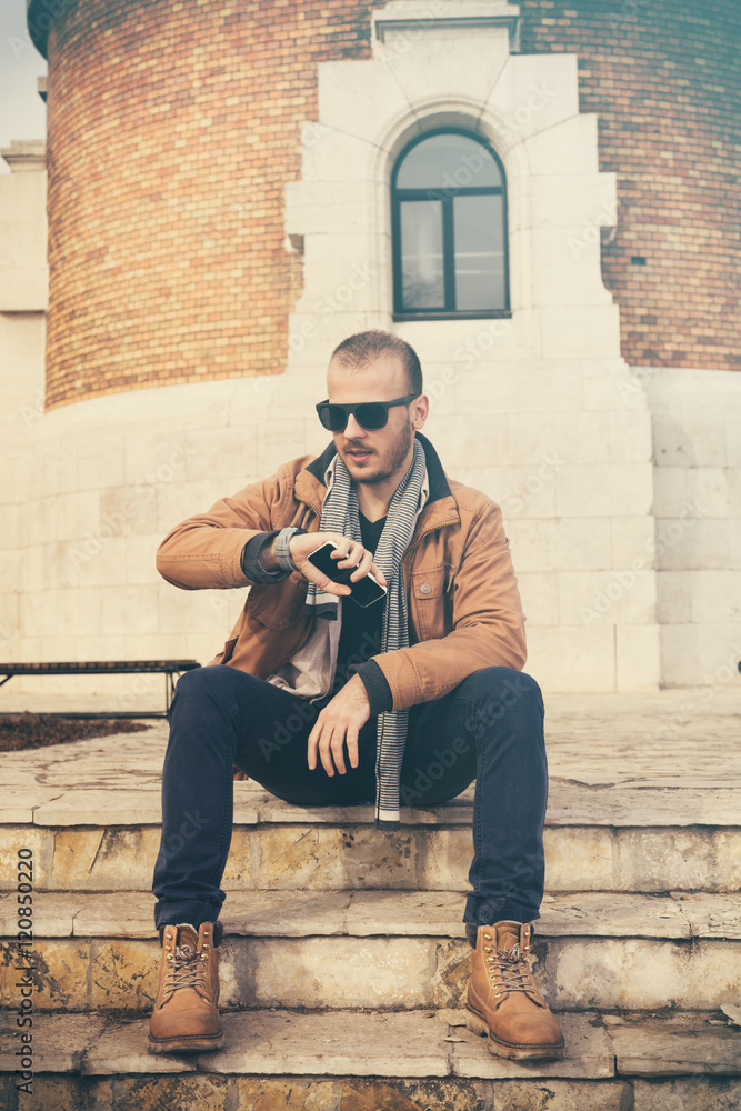 Fototapeta premium Modern guy using cellphone. 