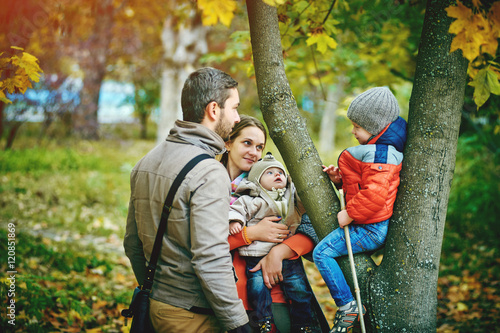 young happy family walking in autumn Park