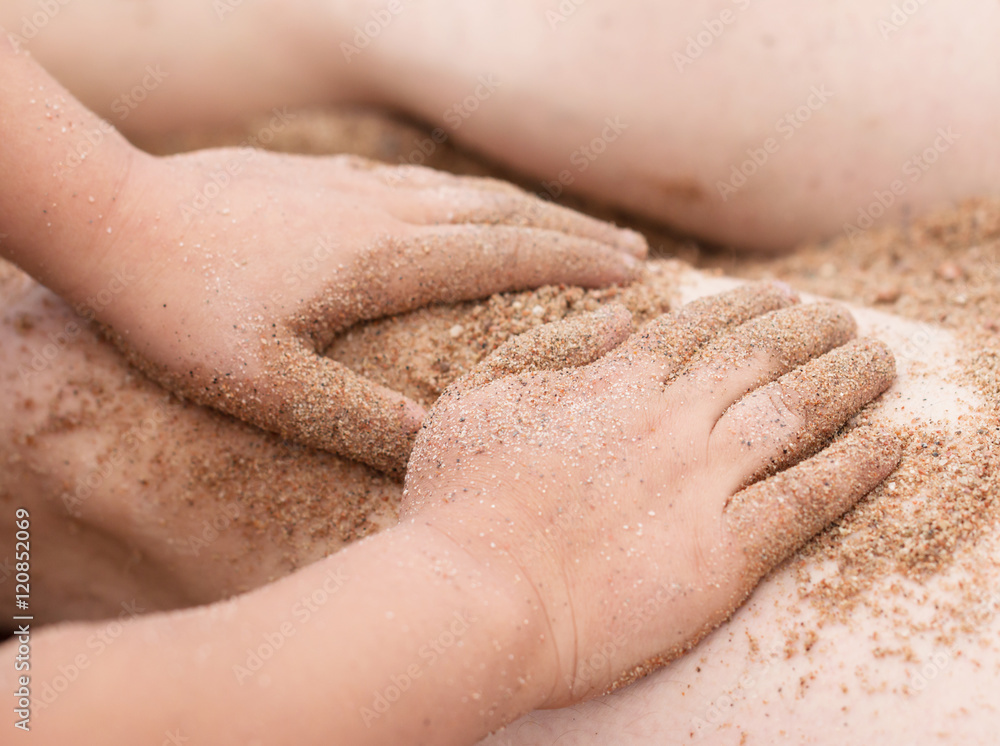 Fototapeta premium Hands in the sand on the beach