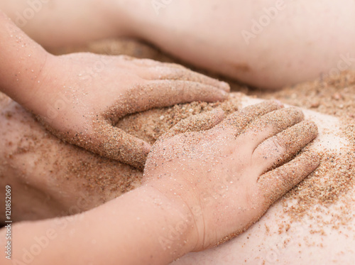 Hands in the sand on the beach