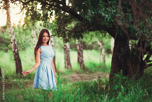 Portrait of pretty girl near the tree in the park. Concept of youth and natural beauty. soft focus