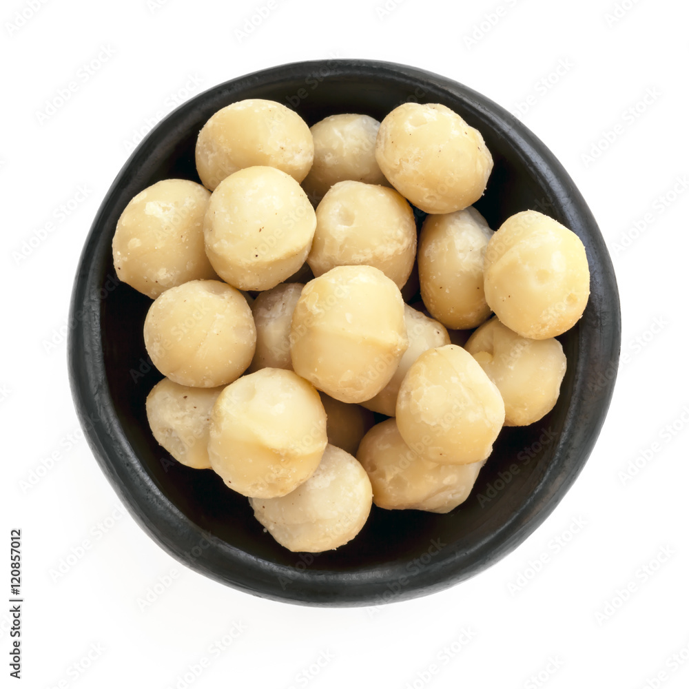 Macadamia Nuts in Black Bowl Overhead View Isolated Macadamia Nuts in Black Bowl Overhead View Isolated