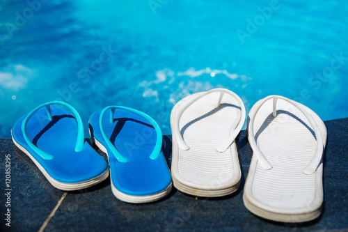 Beach slippers on border of swimming pool