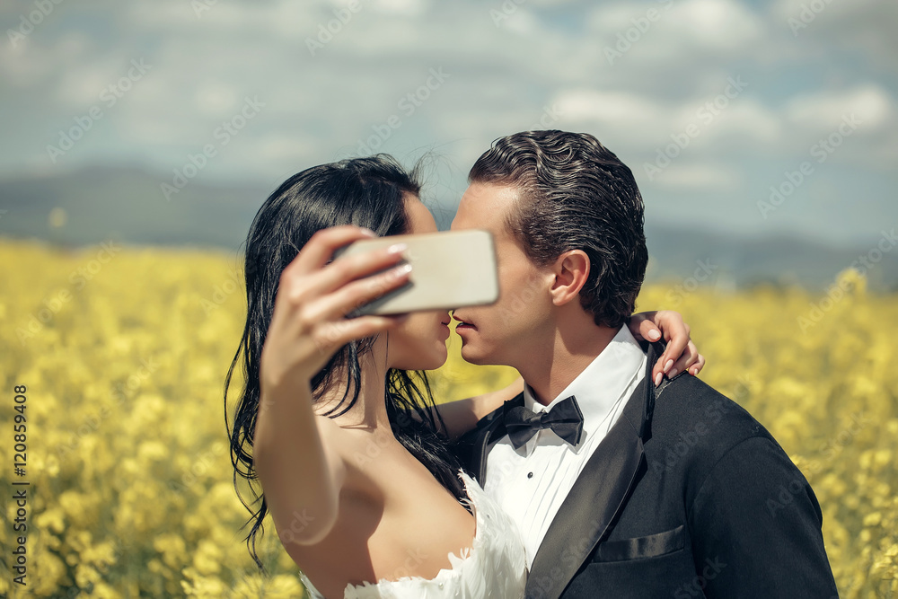wedding couple kiss in field yellow flowers