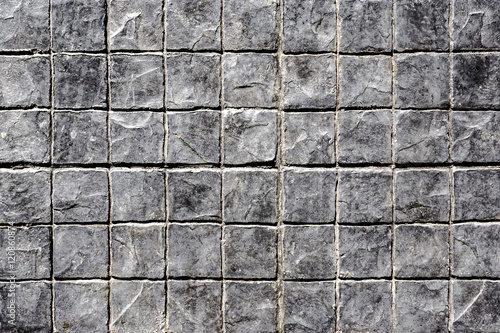 Old grey pavement in a pattern of stone pathway